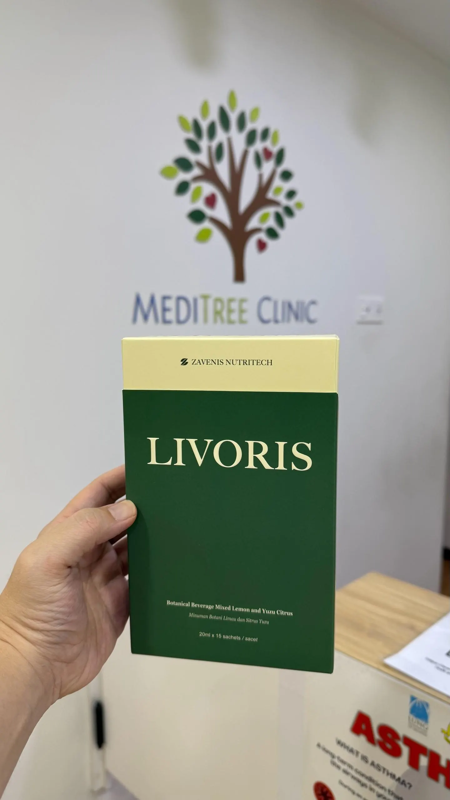 Livoris box held in front of MEDITREE CLINIC signage